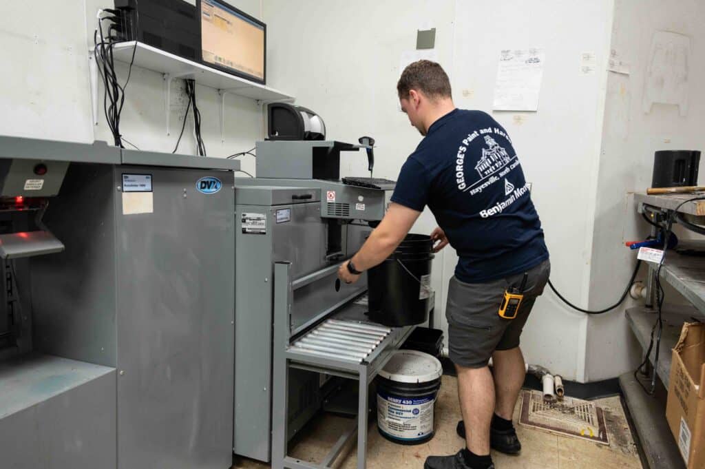 George’s Paint & Hardware employee mixing custom Benjamin Moore paint colors in Hayesville NC