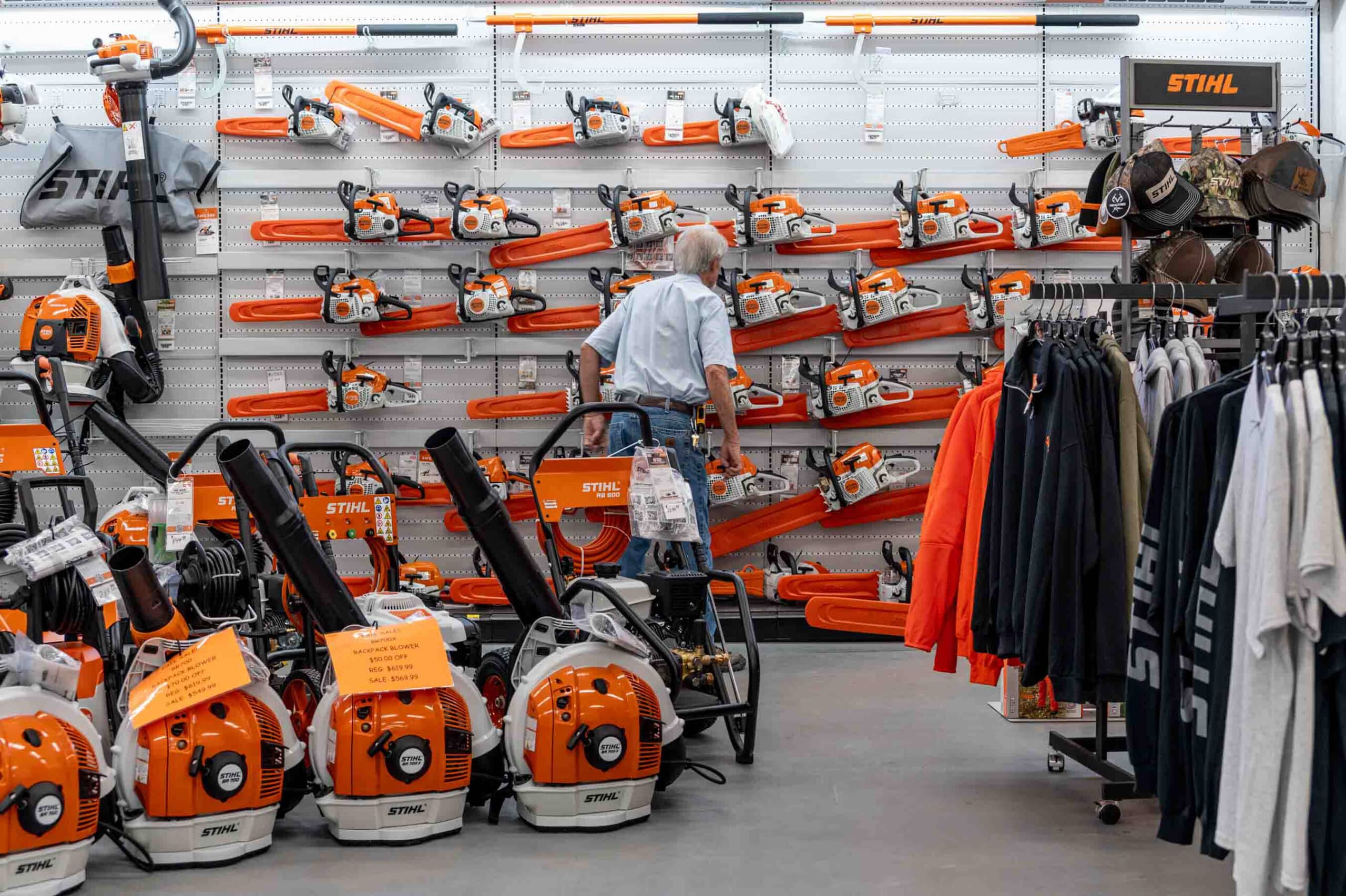 Customer comparing STIHL chainsaws at George’s Paint & Hardware in Hayesville, NC